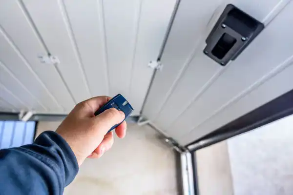 A person using a commercial garage door opener from [account_name].